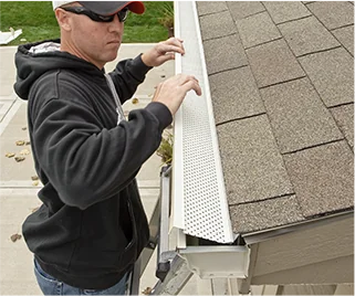 Man installing a gutter guard